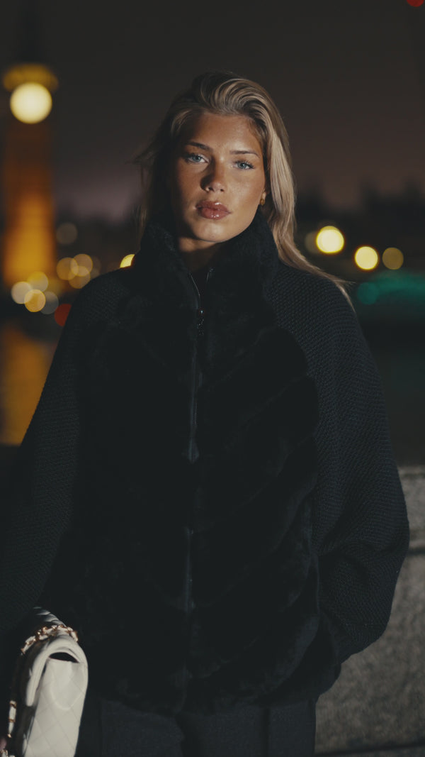 Cenya rex rabbit fur jacket in obsidian black, worn by the Thames at night